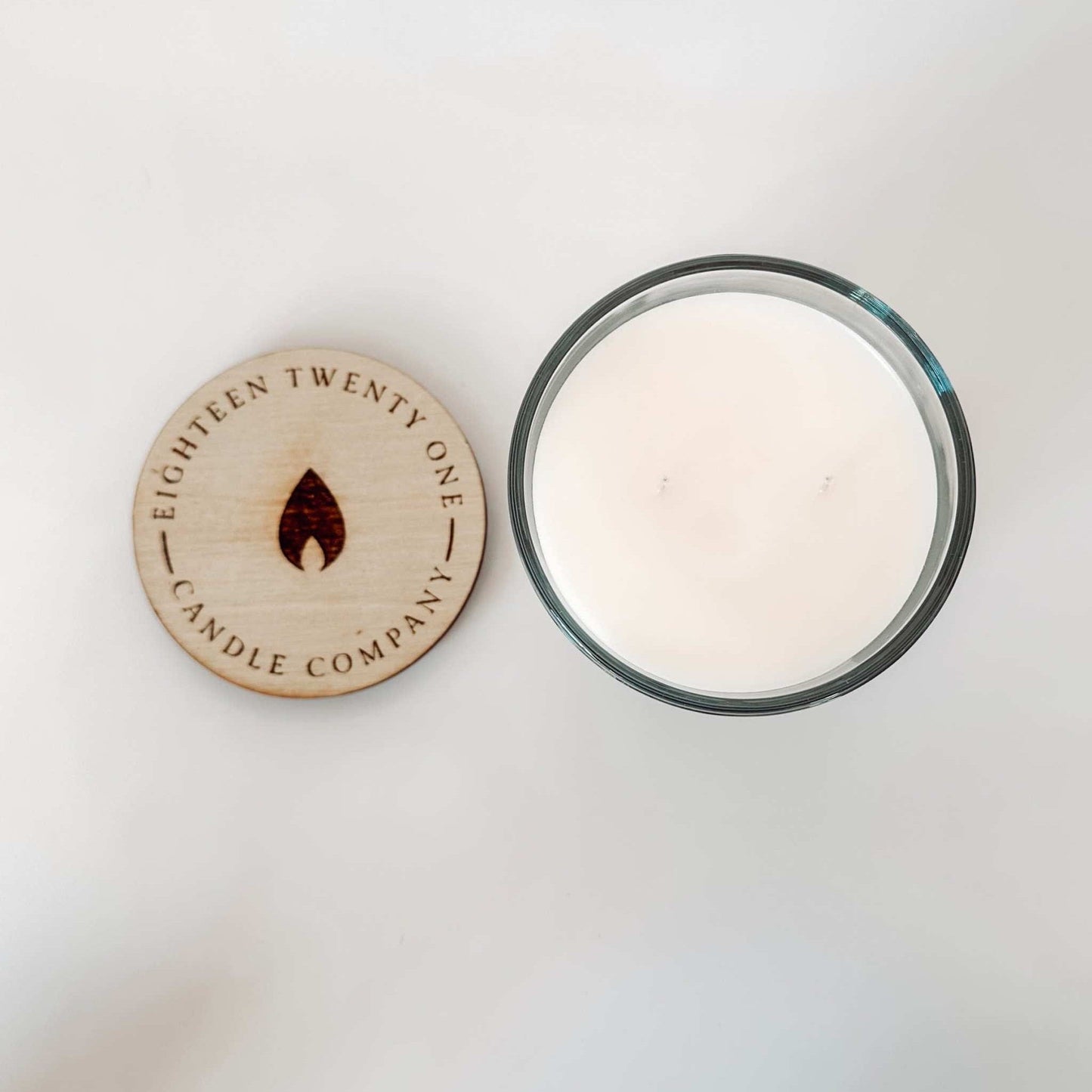 Close up of engraved wooden lid for Mango Cocout Candle with 1821 Candle Co logo.