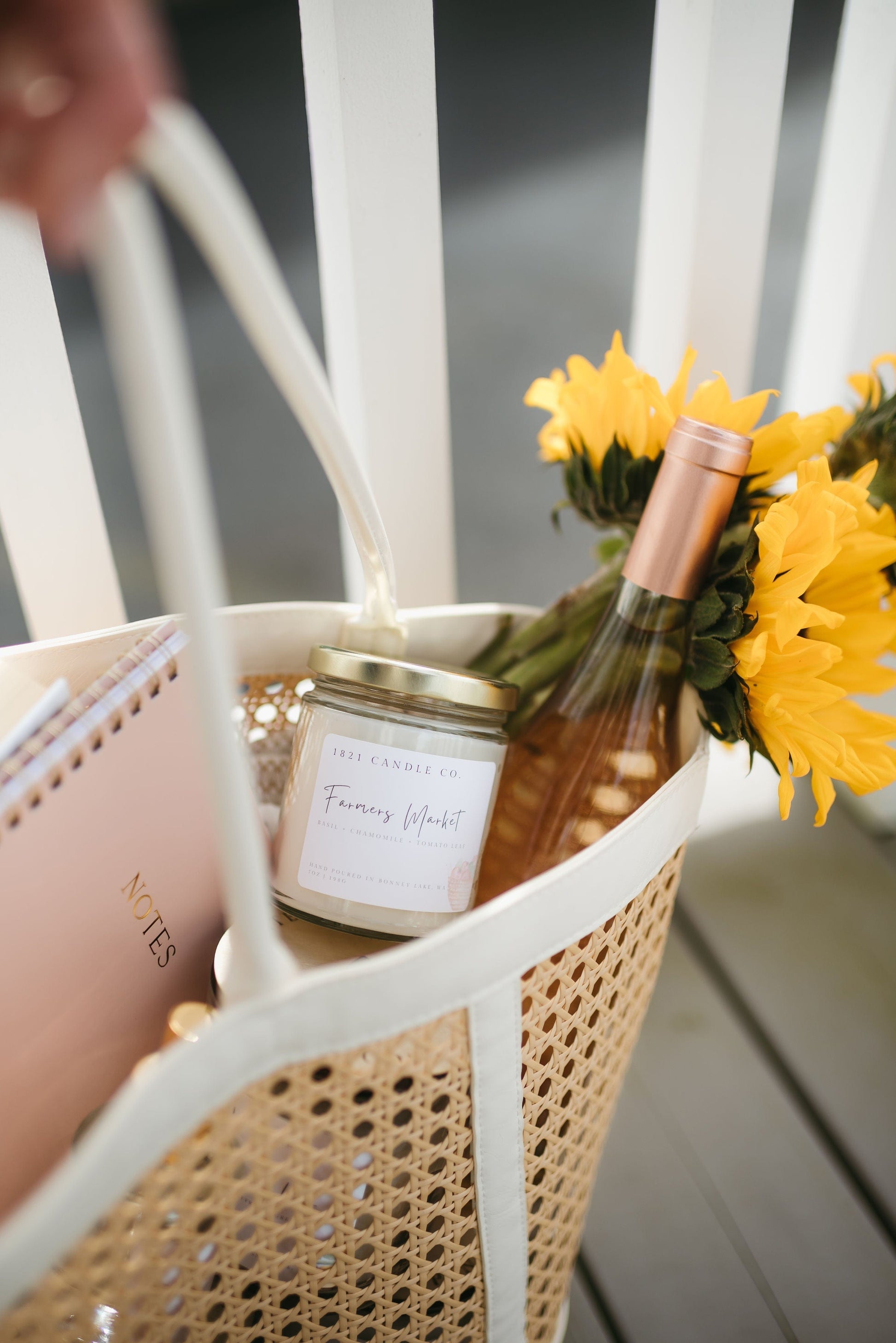 Farmers Market Summer Candle handmade in Bonney Lake by 1821 Candle Co in a woven summer tote with a bottle of rose, sunflowers and fresh basil