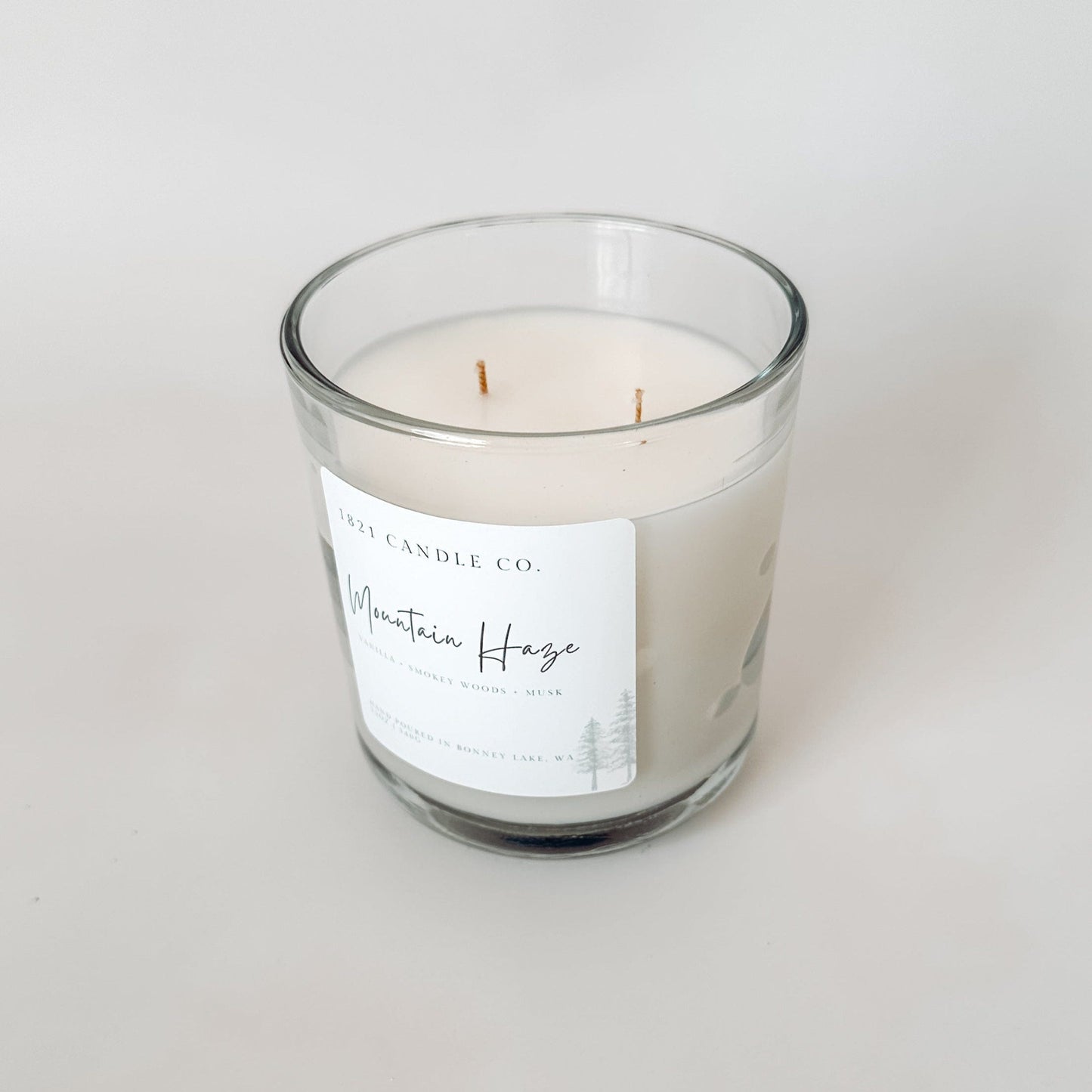 Two wick Mountain Haze candle in a clear jar from 1821 Candle Co. shown on a white background with a farmhouse aesthetic design.