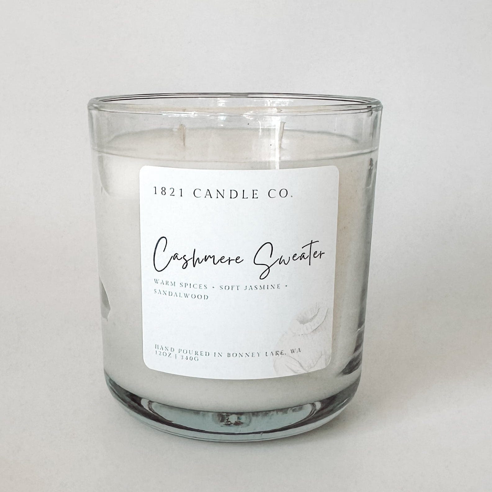 Glass Candle Jar featuring Cashmere Sweater by 1821 Candle Co.. Hand poured and labeled with warm, comforting scent notes like sandalwood and jasmine.