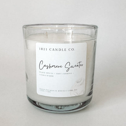 Glass Candle Jar featuring Cashmere Sweater by 1821 Candle Co.. Hand poured and labeled with warm, comforting scent notes like sandalwood and jasmine.