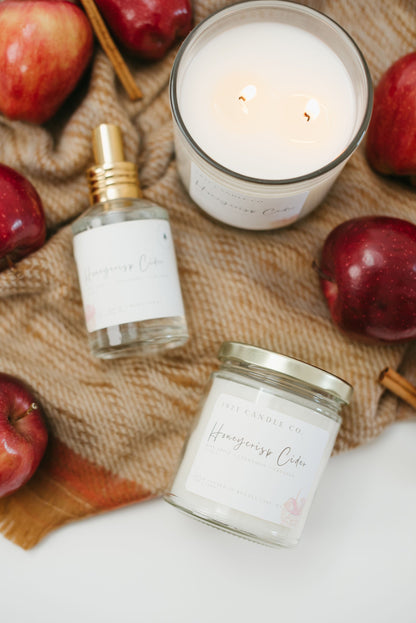 Honeycrisp Cider Candle in 7oz and 12oz and linen spray with apples and orange fall blanket
