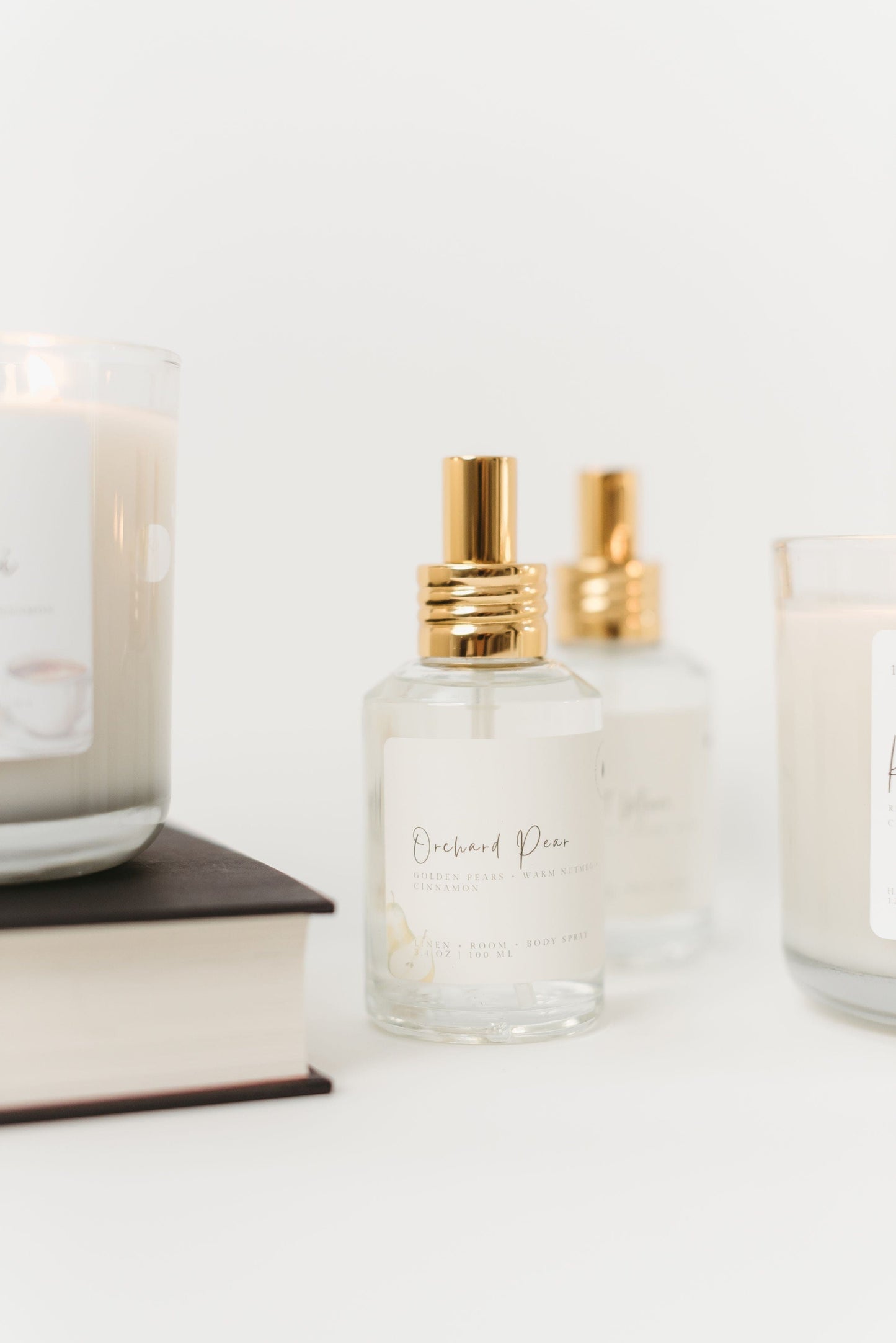 Two perfume bottles with gold caps on a white surface.